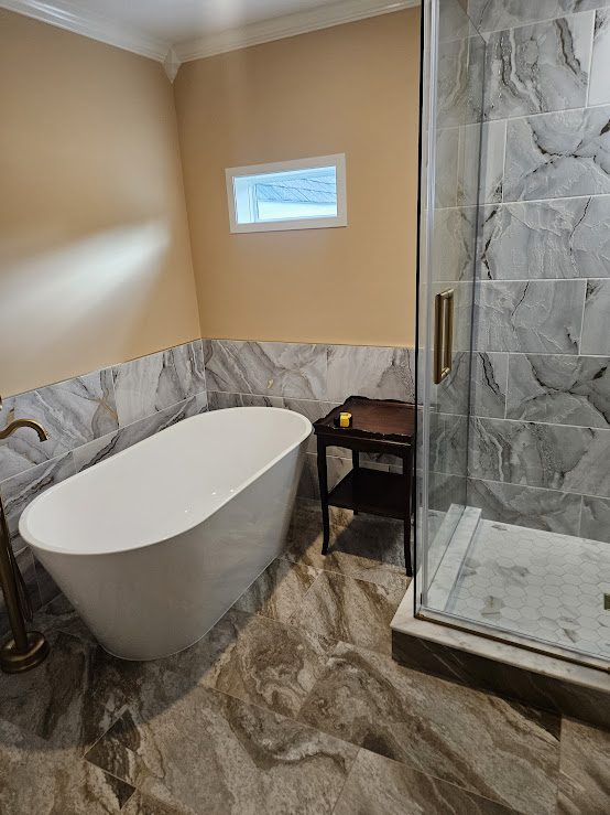 Bathroom with freestanding tub and glass shower