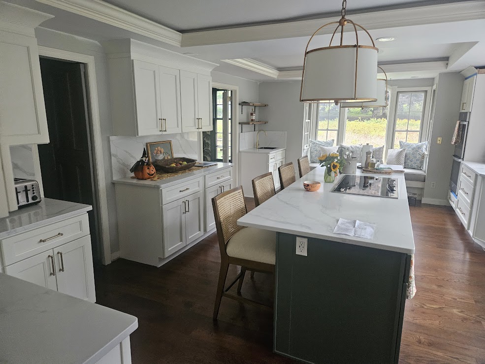 White kitchen with navy island and pendant lights